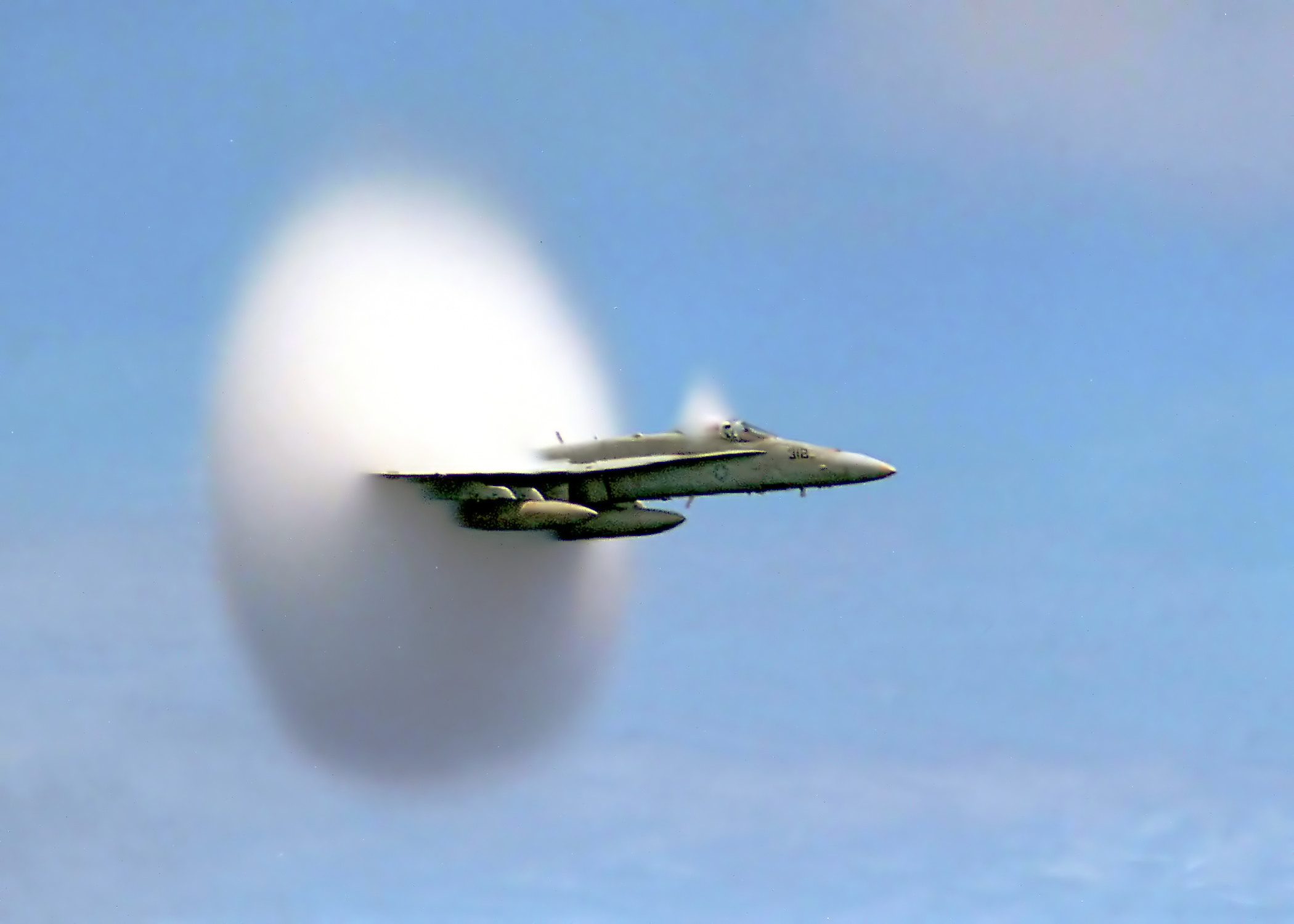 FA-18_Hornet_breaking_sound_barrier_(7_July_1999)_-_filtered